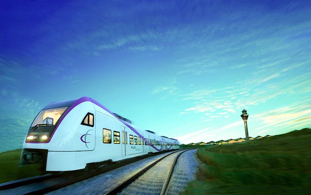 KLIA Express train traveling with control tower in the background, Malaysia.
