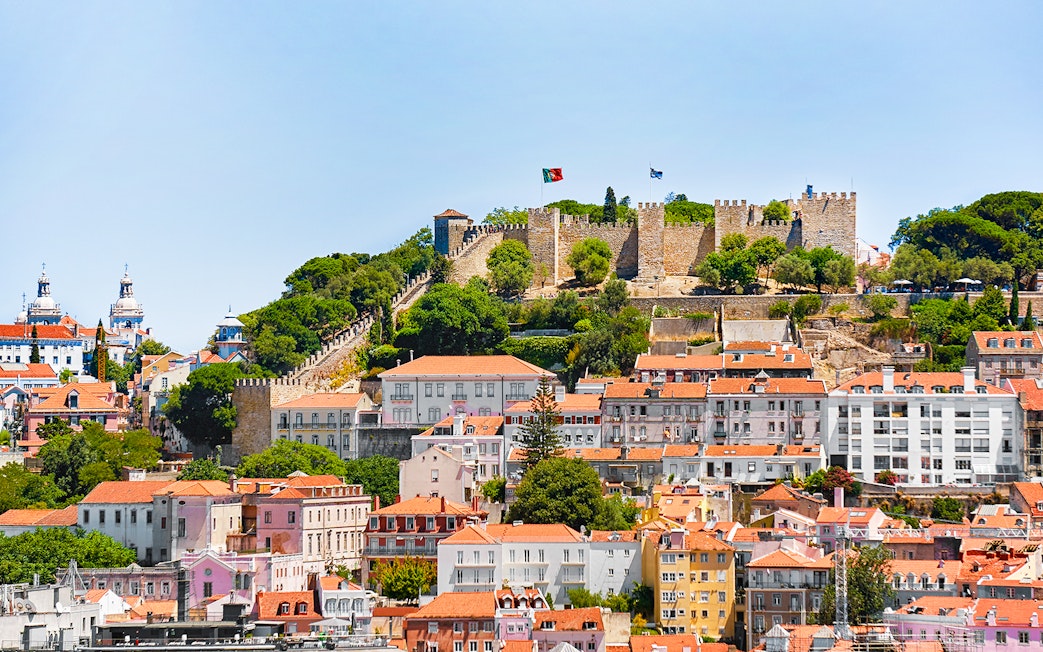 Aerial view of Sao Jorge Castle in Lisbon with surrounding cityscape.