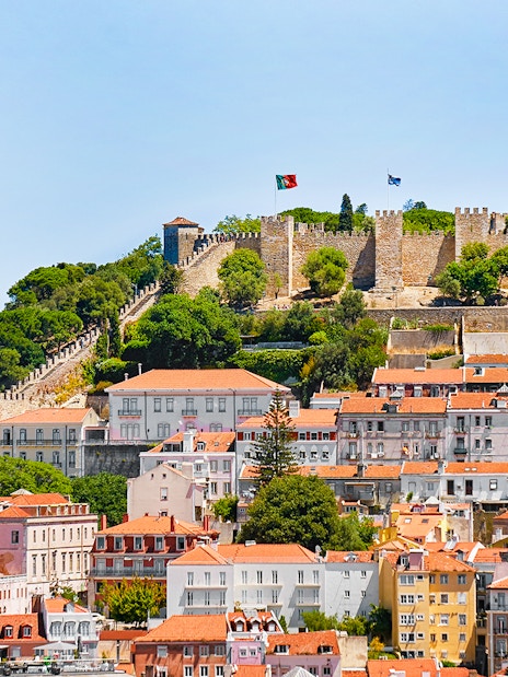 Aerial view of Sao Jorge Castle in Lisbon with surrounding cityscape.