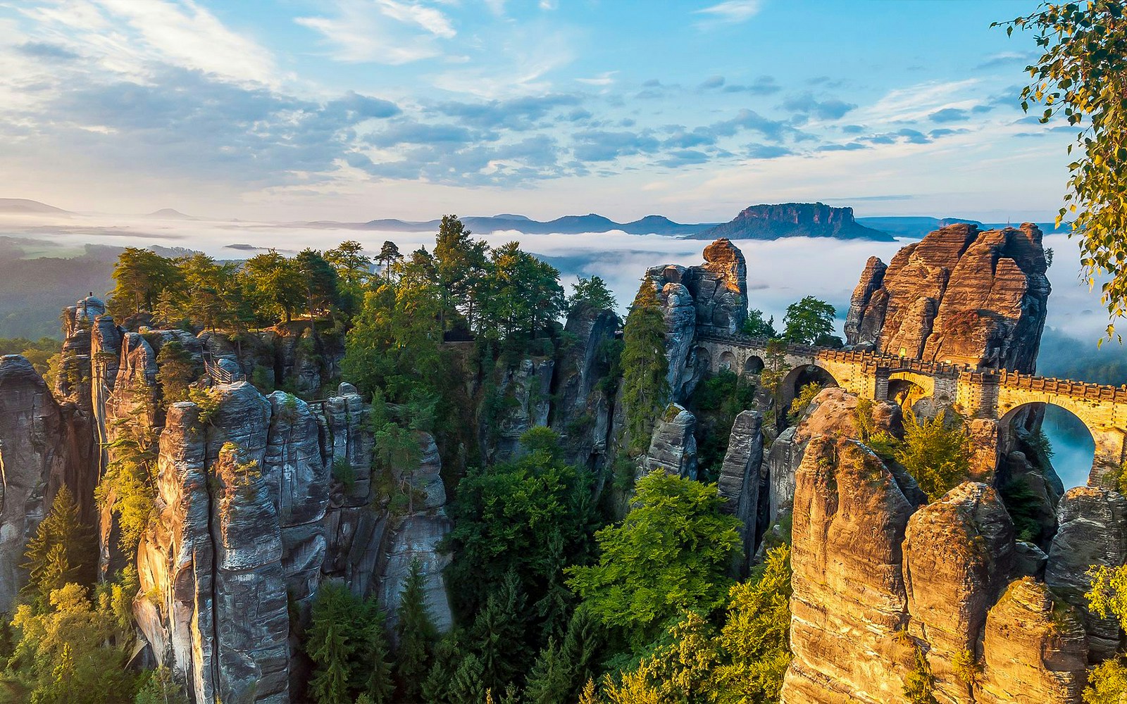 Bastei Bridge in Saxon Switzerland with rock formations and forest.