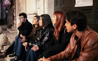 Group of people listening to a guide during a haunted ghosts tour in Rome.