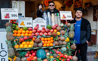 Fruit stand with pomegranates, oranges, and coconuts on Istanbul food tour.