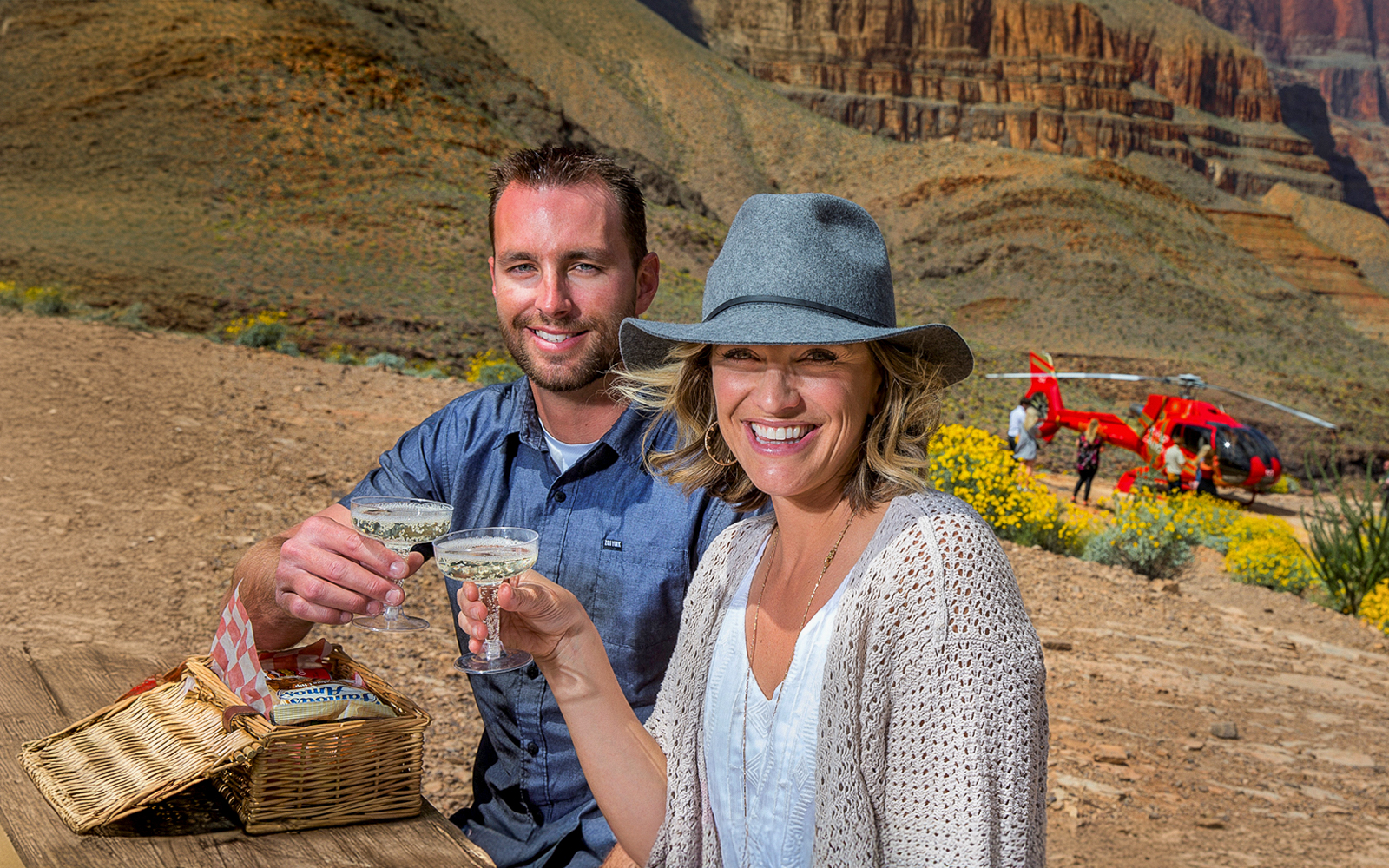 Couple enjoying champagne picnic during Grand Canyon helicopter tour with landing.