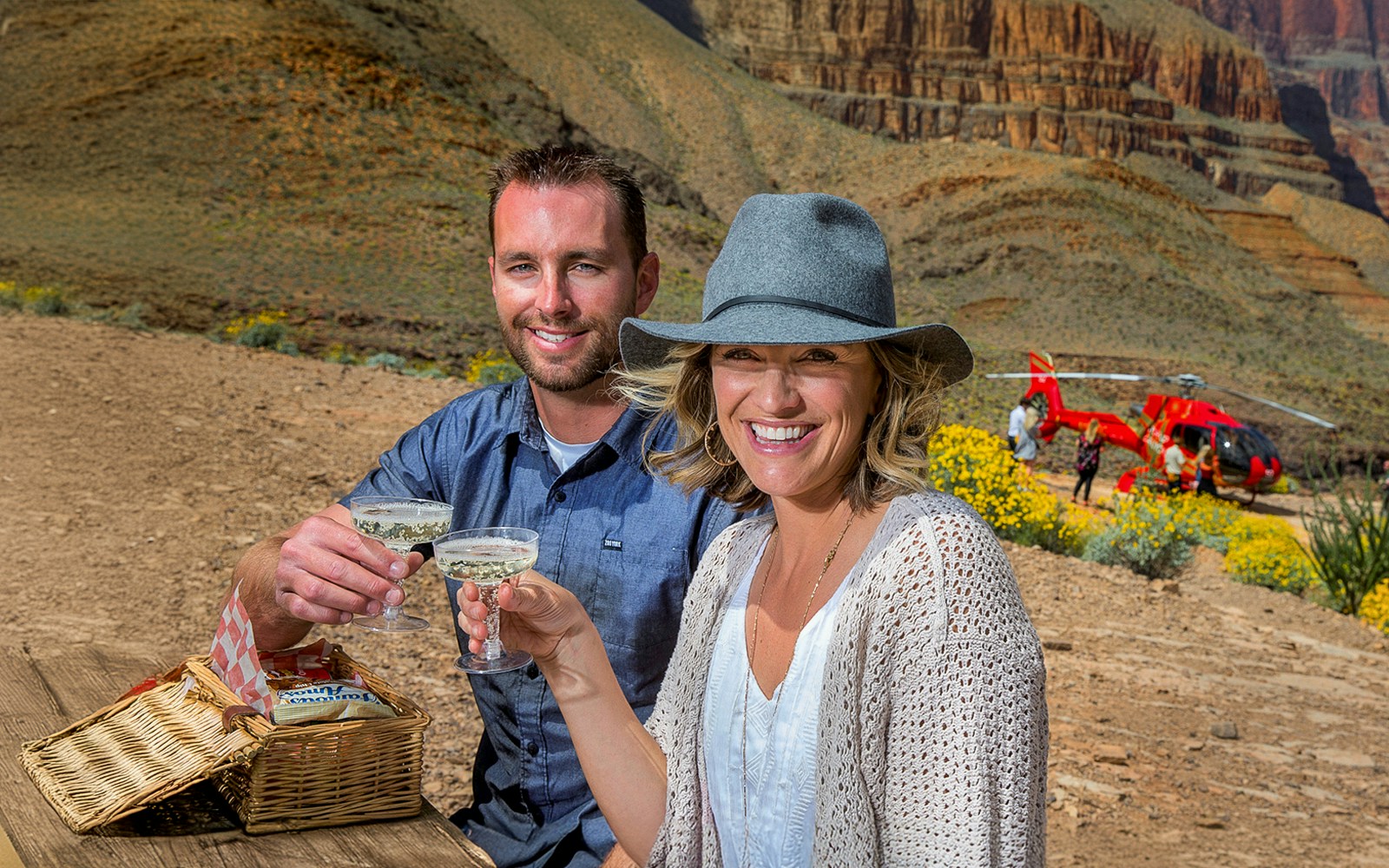 Couple enjoying champagne picnic during Grand Canyon helicopter tour with landing.