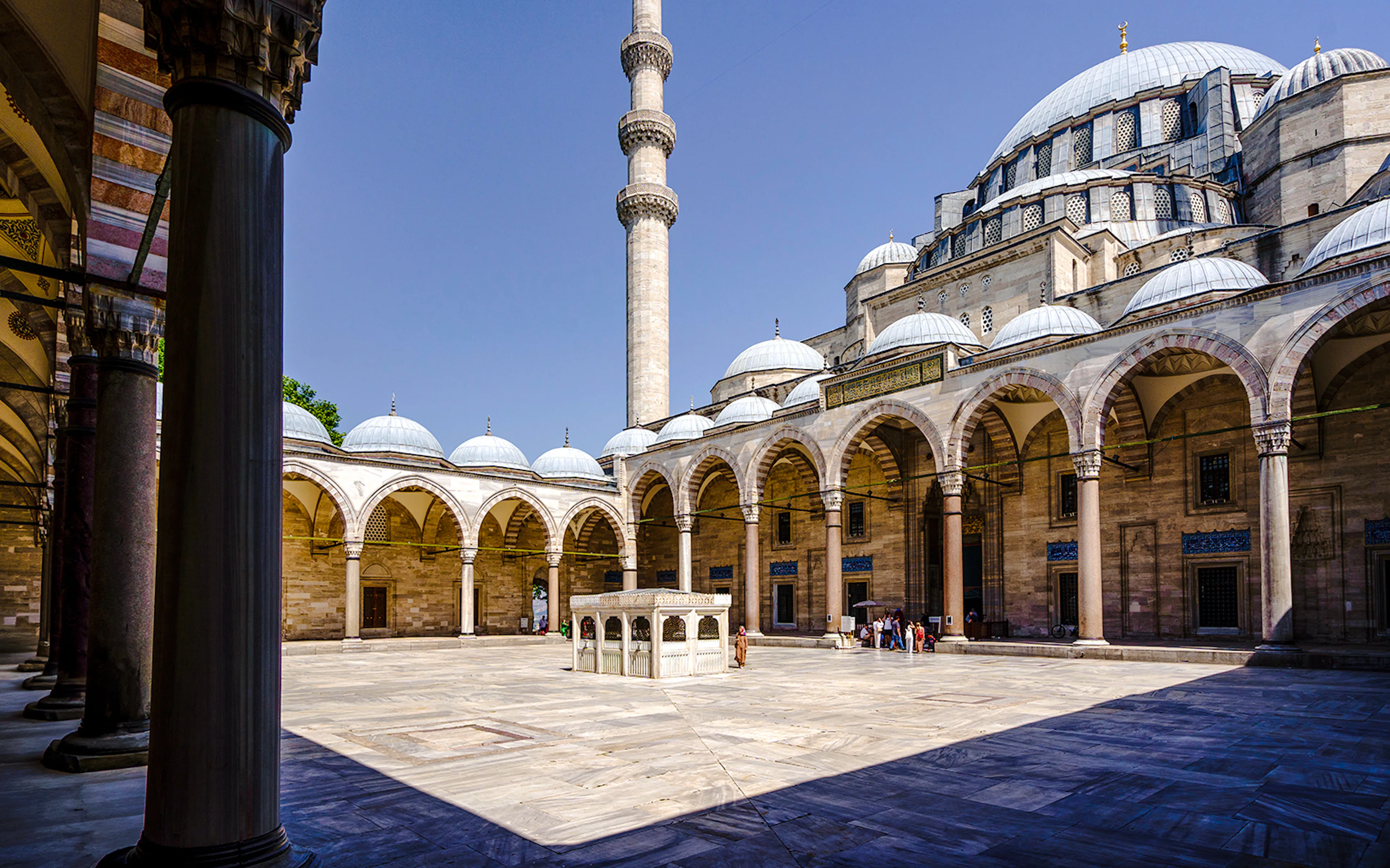 Inner courtyard of Suleymaniye Mosque with arches and central fountain, Istanbul.