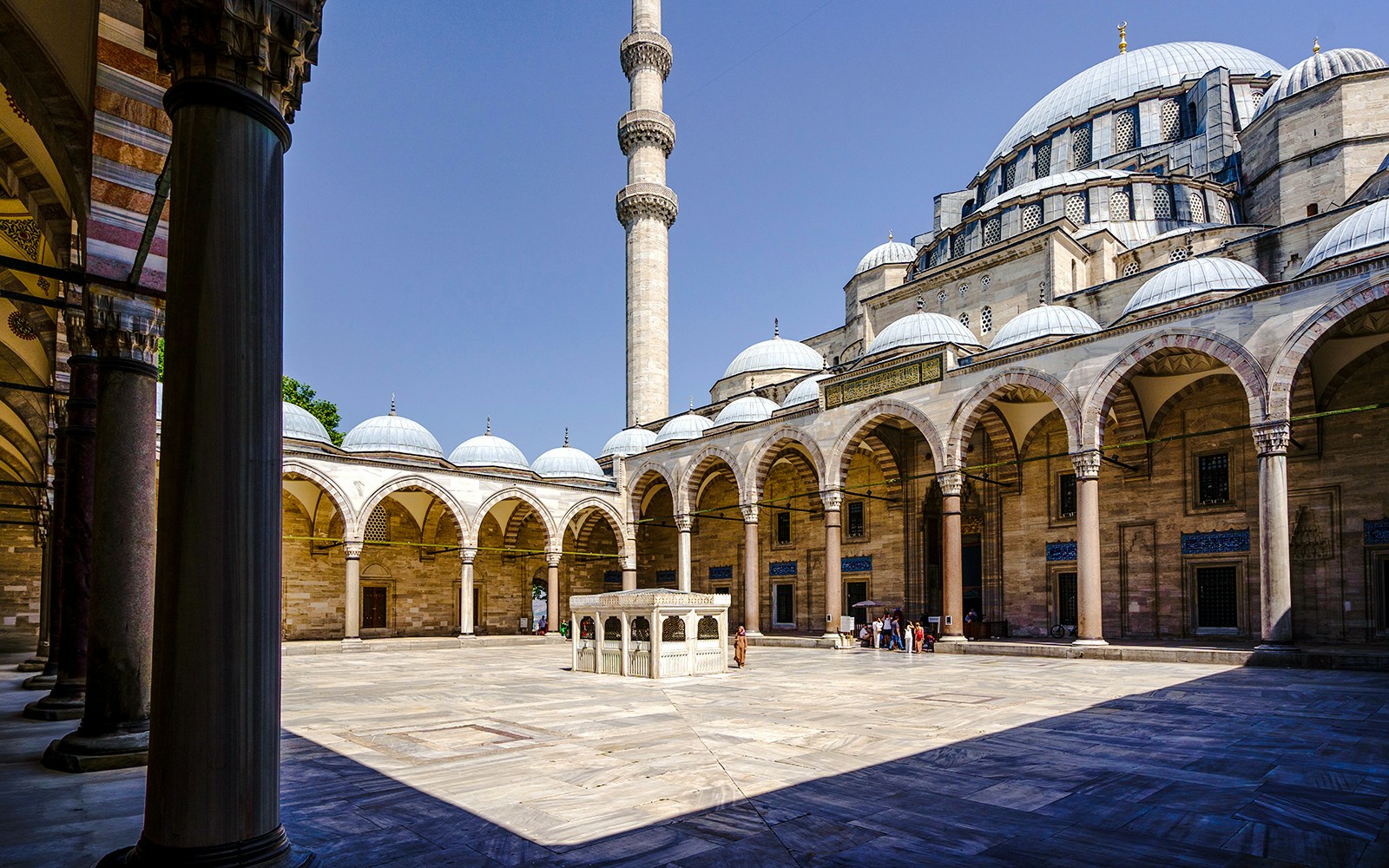Inner courtyard of Suleymaniye Mosque with arches and central fountain, Istanbul.