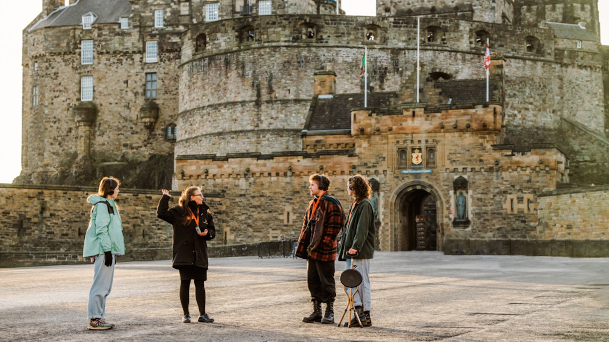 Tour guide explaining Edinburgh Castle to visitors on the Secrets of the Royal Mile Tour.