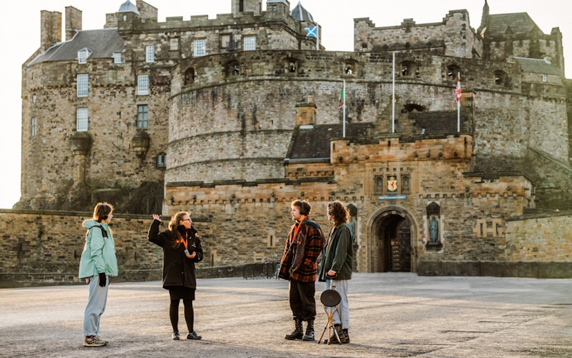 Tour guide explaining Edinburgh Castle to visitors on the Secrets of the Royal Mile Tour.