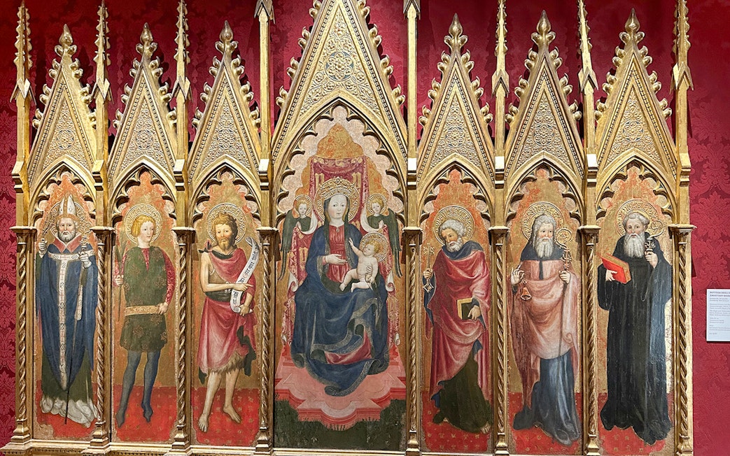 Medieval religious artwork inside Castel Sant'Angelo, Rome, depicting saints and Madonna.