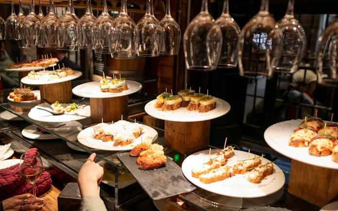Tapas selection on display at a Barcelona wine bar during a side streets tour.