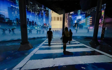 Visitors walking through immersive digital cityscape at ARTECHOUSE DC exhibit.