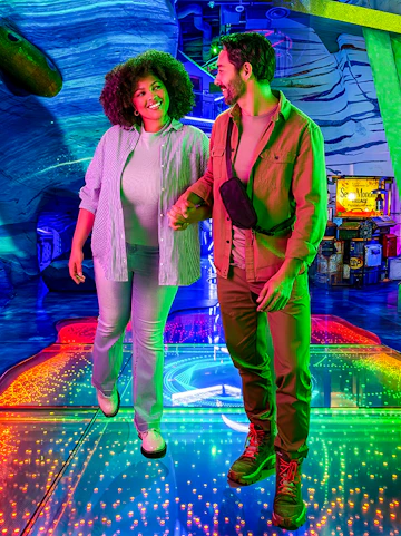 Couple exploring colorful interactive exhibit at Omega Mart, Las Vegas.