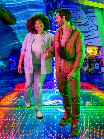 Couple exploring colorful interactive exhibit at Omega Mart, Las Vegas.