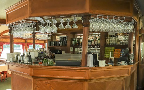Bar area on a Budapest evening dinner cruise with glasses and bottles displayed.