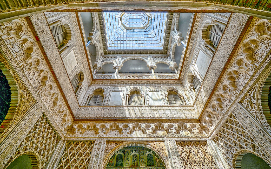 Hall of Ambassadors ceiling with intricate Moorish designs in Alcazar of Seville.