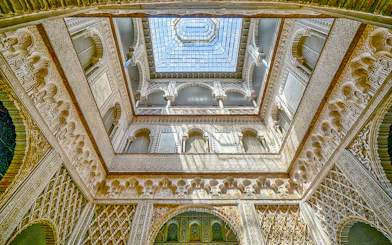 Hall of Ambassadors ceiling with intricate Moorish designs in Alcazar of Seville.