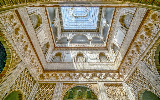 Hall of Ambassadors ceiling with intricate Moorish designs in Alcazar of Seville.