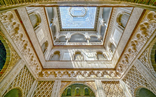 Hall of Ambassadors ceiling with intricate Moorish designs in Alcazar of Seville.