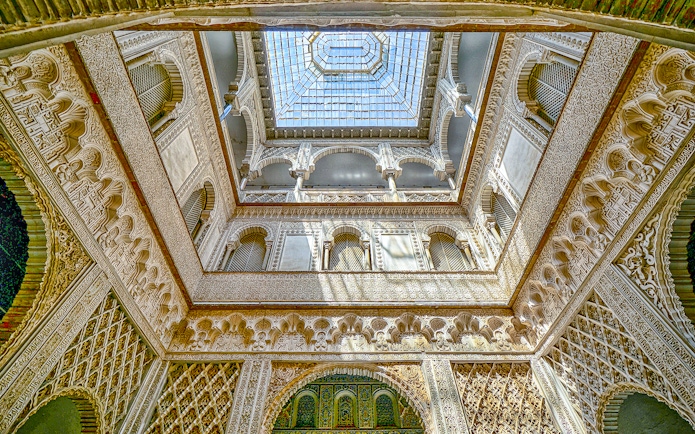 Hall of Ambassadors ceiling with intricate Moorish designs in Alcazar of Seville.