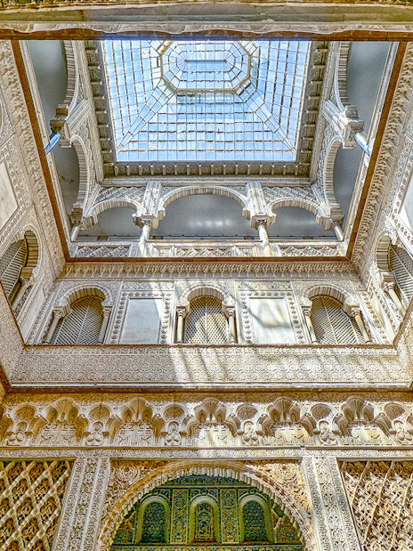 Hall of Ambassadors ceiling with intricate Moorish designs in Alcazar of Seville.