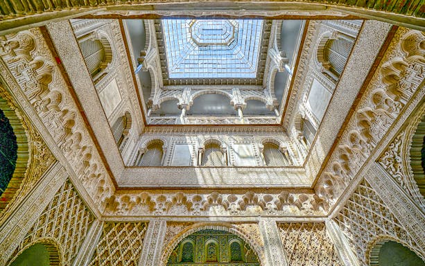 Hall of Ambassadors ceiling with intricate Moorish designs in Alcazar of Seville.