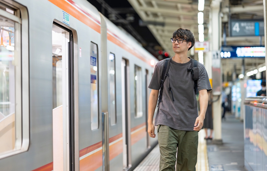 Man boarding train at a station in Bruges, Belgium.