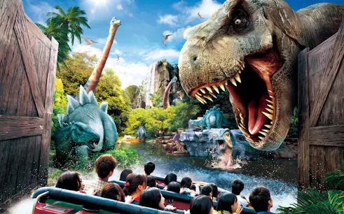 Visitors on a boat ride encounter dinosaurs at Jurassic Park: The Ride, Universal Studios Japan.