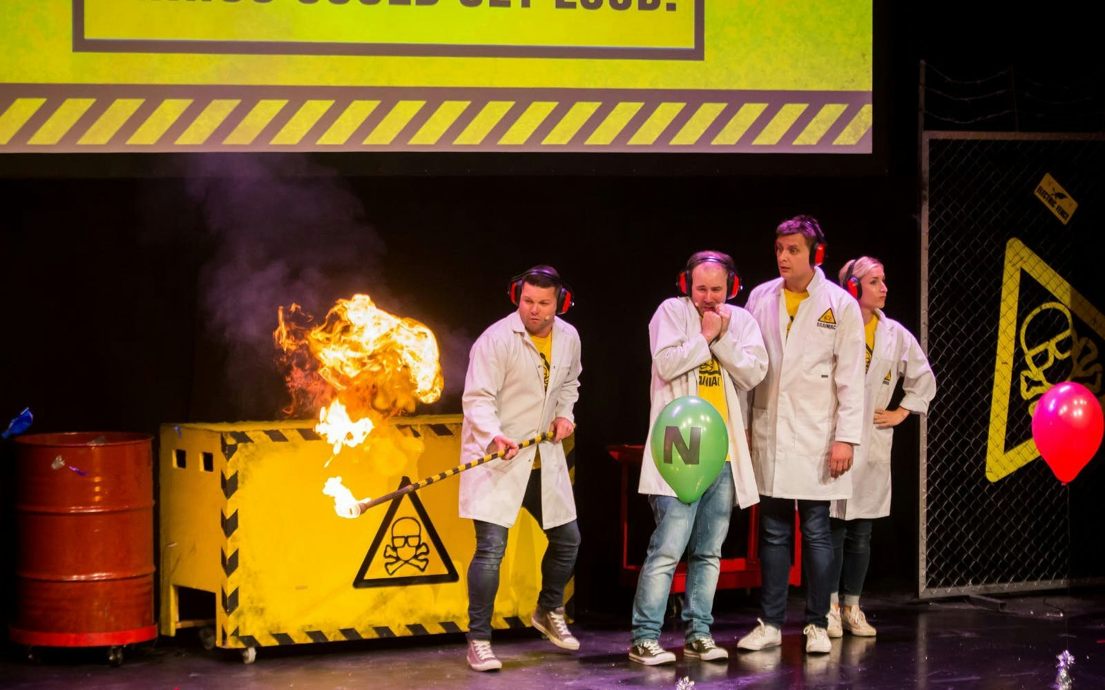 Scientists performing explosive experiment on stage at Brainiac Live Westend.