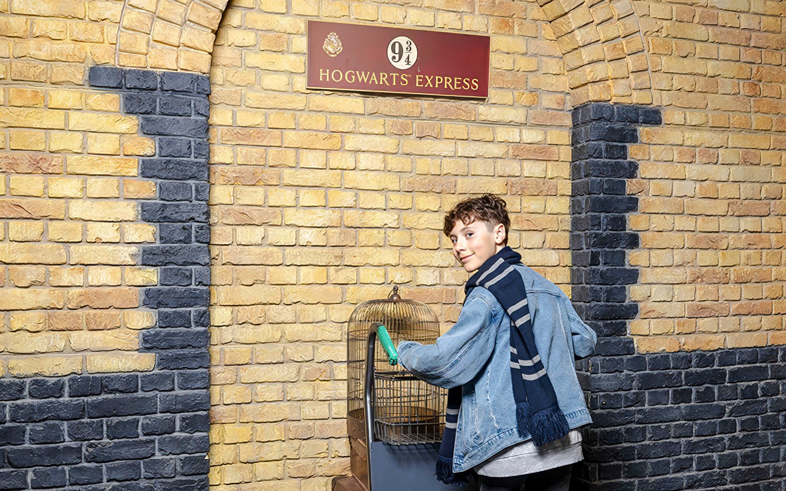 Tourist at Platform 9¾ with luggage cart at Harry Potter set.