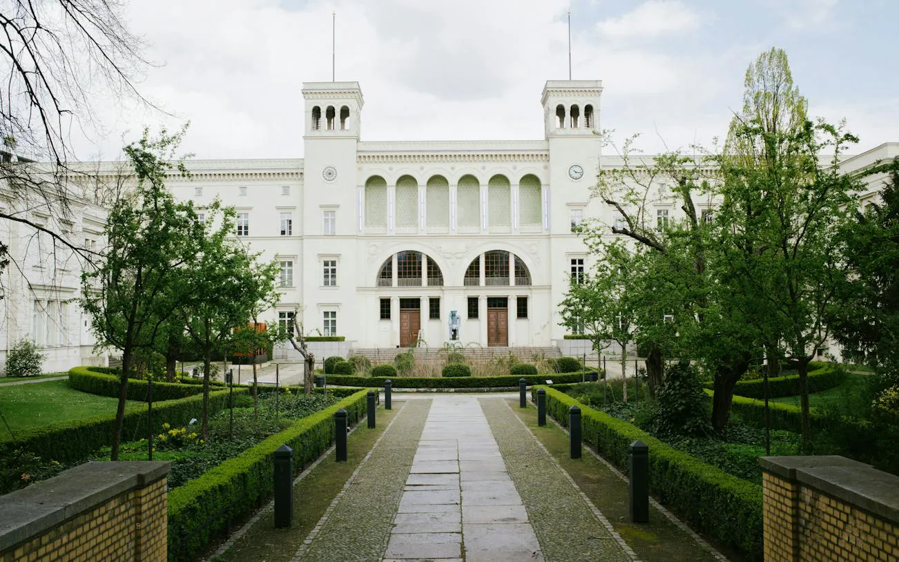 Berlin museum with garden path, part of Secrets of Berlin Spy Mission game.