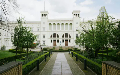 Berlin museum with garden path, part of Secrets of Berlin Spy Mission game.
