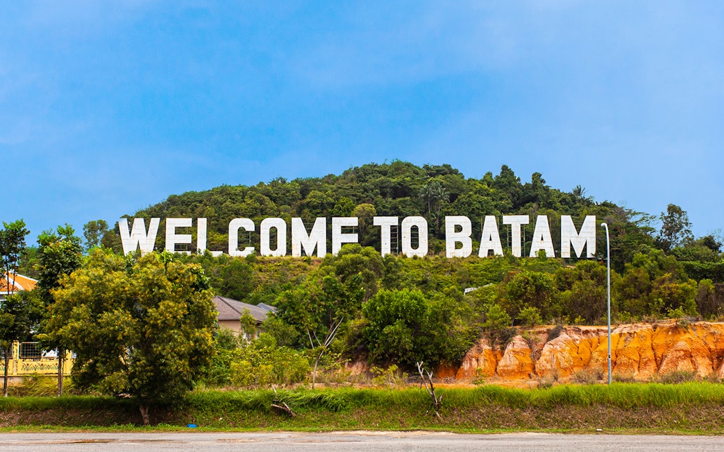 Welcome sign on a hill in Batam, Indonesia, part of Harmoni One Batam tour package.