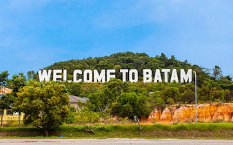 Welcome sign on a hill in Batam, Indonesia, part of Harmoni One Batam tour package.