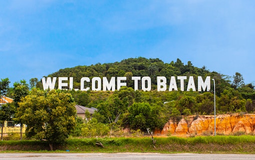 Welcome sign on a hill in Batam, Indonesia, part of Harmoni One Batam tour package.