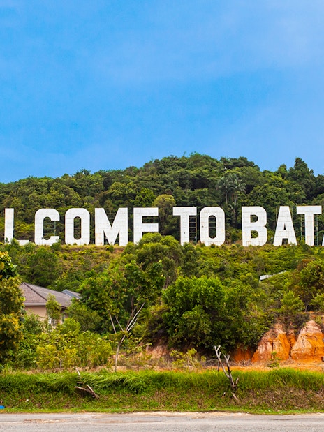 Welcome sign on a hill in Batam, Indonesia, part of Harmoni One Batam tour package.