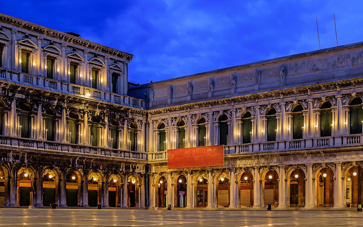 Correr Museum facade illuminated at night in Venice, Italy.