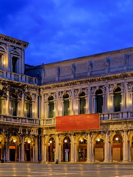 Correr Museum facade illuminated at night in Venice, Italy.