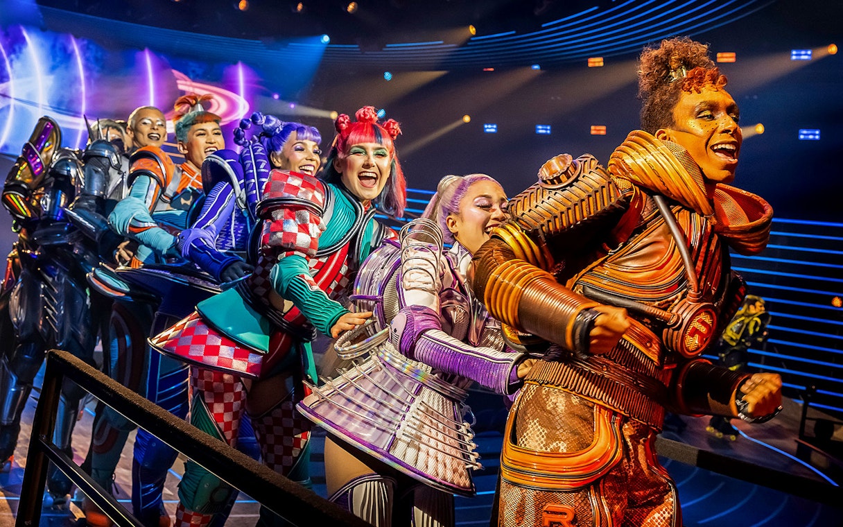 Performers in colorful costumes on stage during Starlight Express show.