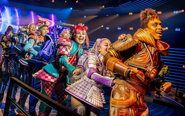 Performers in colorful costumes on stage during Starlight Express show.