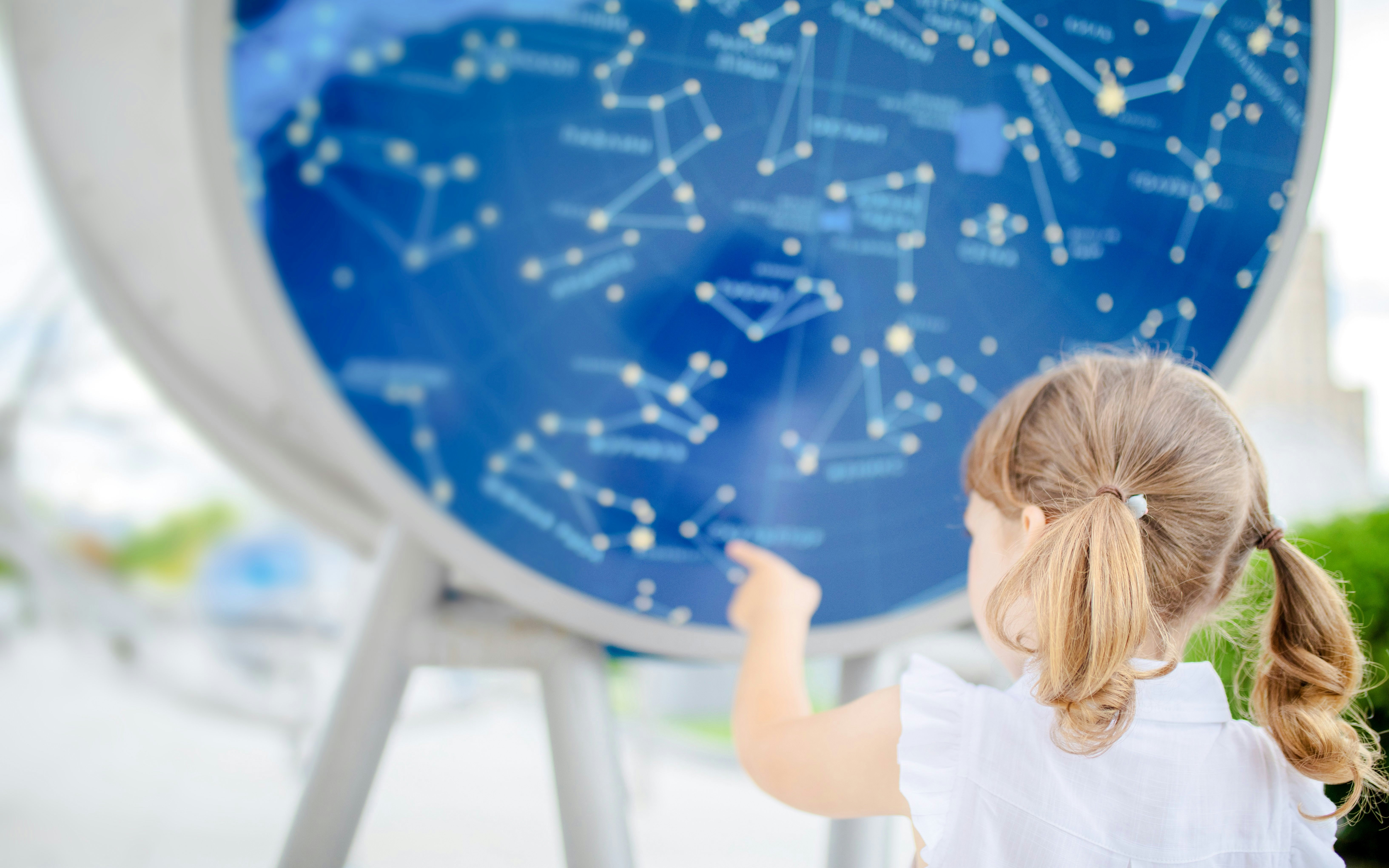 Child pointing at constellation map at Scienceworks exhibit.