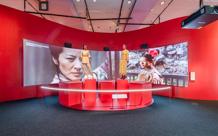 Exhibit at Art Science Museum's Future World featuring film costumes and screen display.