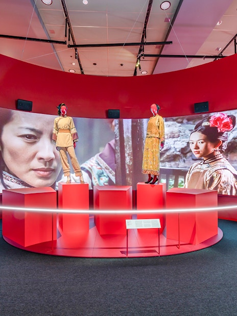 Exhibit at Art Science Museum's Future World featuring film costumes and screen display.