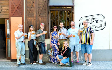 Group enjoying Czech beer on Prague food tour outside a local pub.