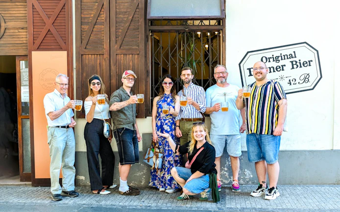 Group enjoying Czech beer on Prague food tour outside a local pub.