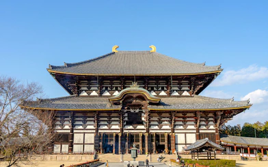 Tōdai-ji Temple's Great Buddha Hall in Nara, Japan, with visitors exploring the grounds.