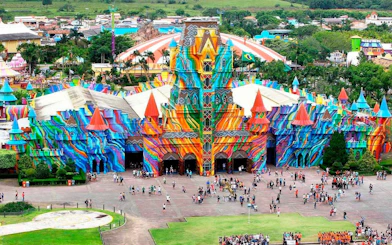 Colorful entrance of Beto Carrero World theme park in Brazil with visitors gathered outside.