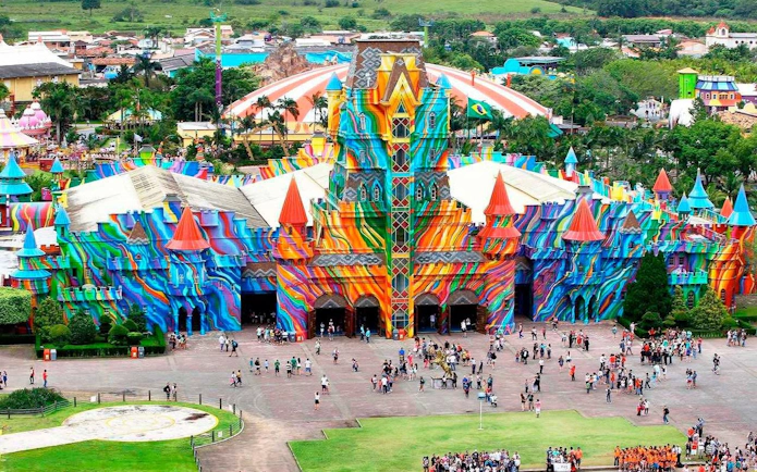 Colorful entrance of Beto Carrero World theme park in Brazil with visitors gathered outside.