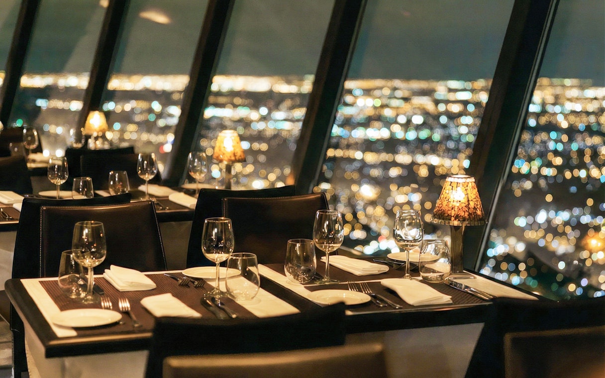 Dining tables with city view at Sky Tower Orbit 360° in Auckland.