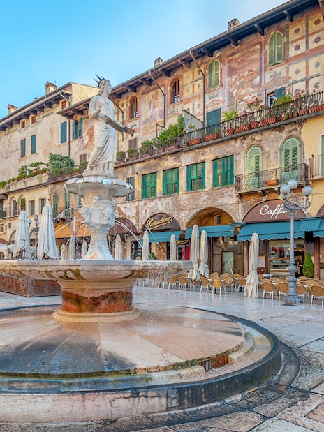 Fountain in Piazza delle Erbe with Palazzo Maffei in Verona, Italy.