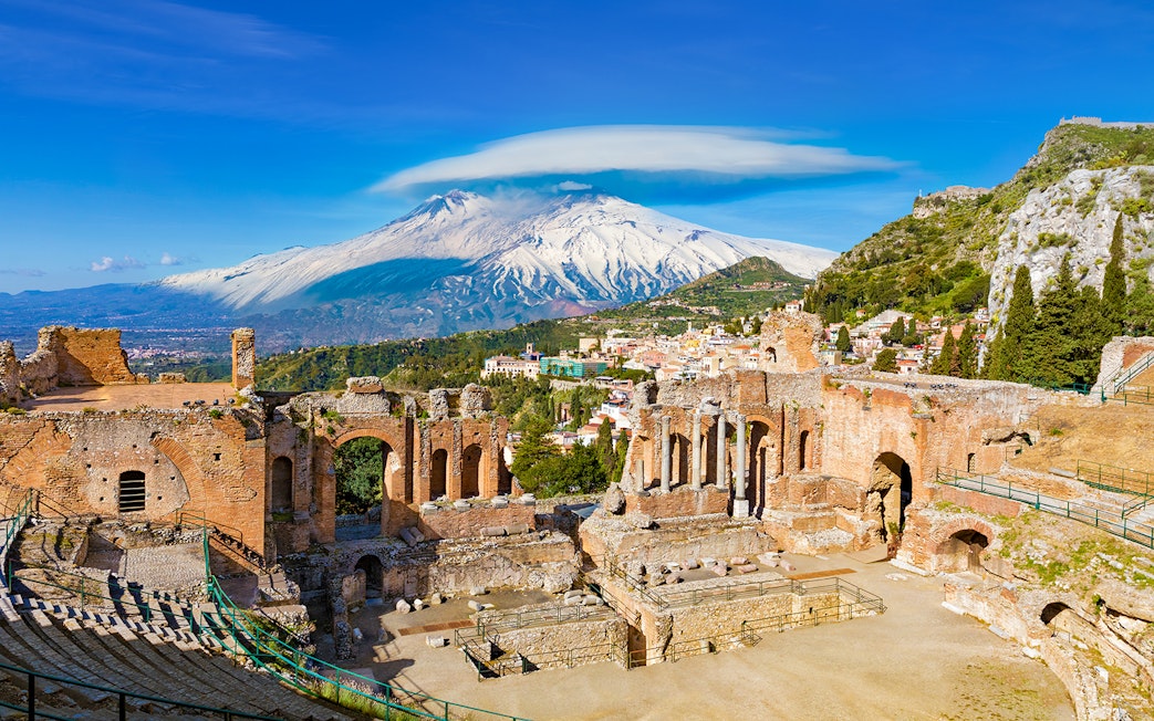 Ancient Greek Theatre in Taormina with Mount Etna in the background, Sicily.
